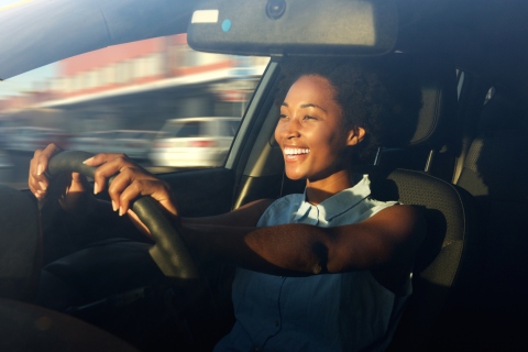 African-American woman smiling during her rush hour daily commute