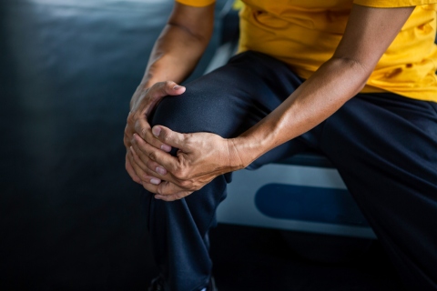 Man experiencing knee pain while working out - a concept of common workout injuries.
